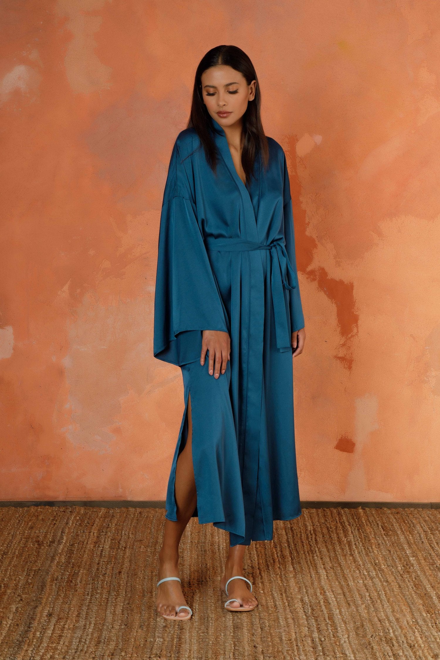 The Ink Signature Mid-Length Robe is our modern and relaxed go-to for lounging around the house or layering over your look to head out the door and take on the day. Featuring subtly flared sleeves, to-the-knee side slits, and hidden on seam pockets (for all the important little things) you’ve just found the statement piece your wardrobe’s been missing.   All the pieces in our LOUNGE collection have been developed in a washable satin that feels like silk but can wash, wear, jet set, repeat.